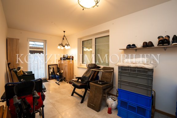 Helle, aufgeräumte Wohnräume mit Stühlen, Schuhen und einem Fenster.